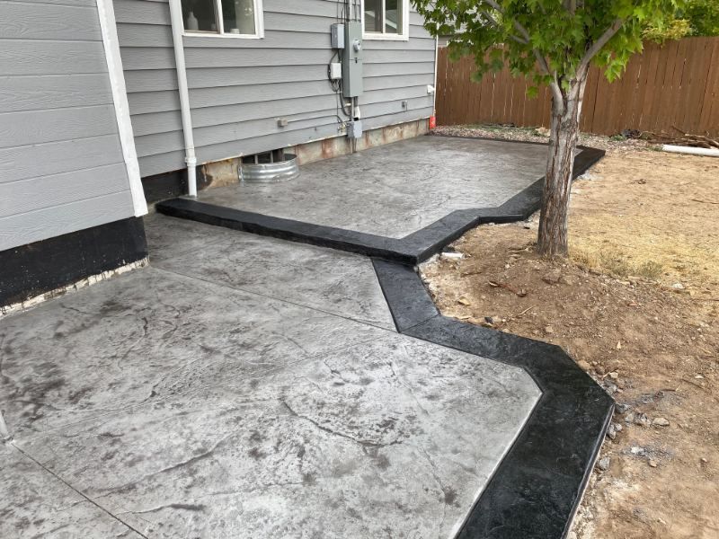 Gray stamped concrete patio with a dark border