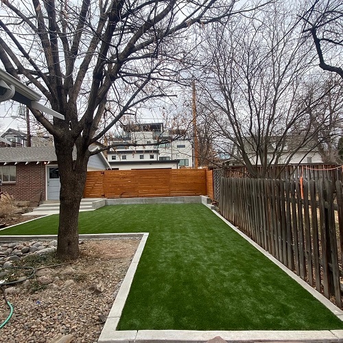 new artificial turf installed with concrete border